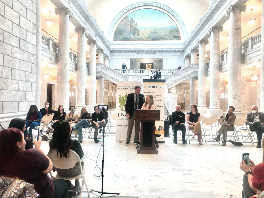 Press conference after the passing of the Utah Clean Slate Law. Noella Sudbury, J.D. is standing at the podium with Representative James A. Dunnigan in the State Capitol Building