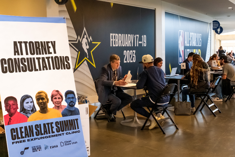 Attorney's offer consultations at tables in the Vivint Arena