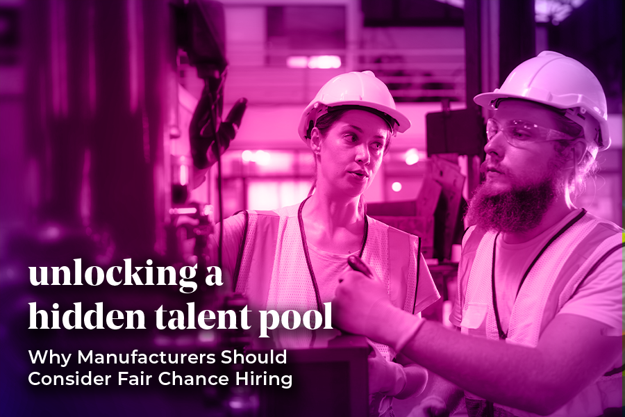 Two workers wearing hard hats and safety vests are in a manufacturing setting, engaged in discussion. The image has a pink overlay with the text: "Unlocking a hidden talent pool – Why Manufacturers Should Consider Fair Chance Hiring."